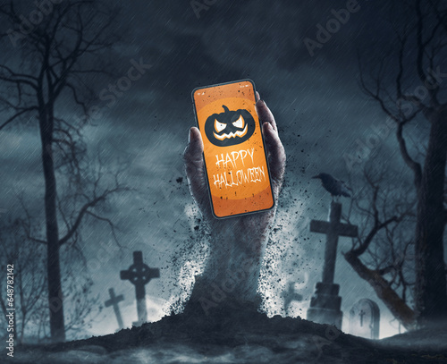 Zombie holding a smartphone with Halloween wishes photo