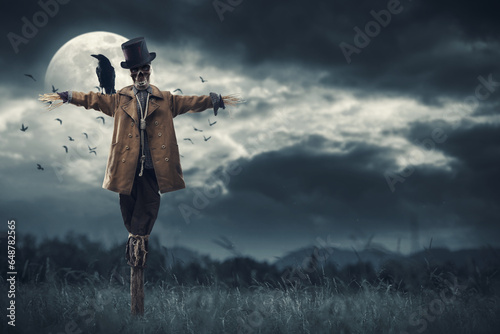 Creepy scarecrow and full moon photo