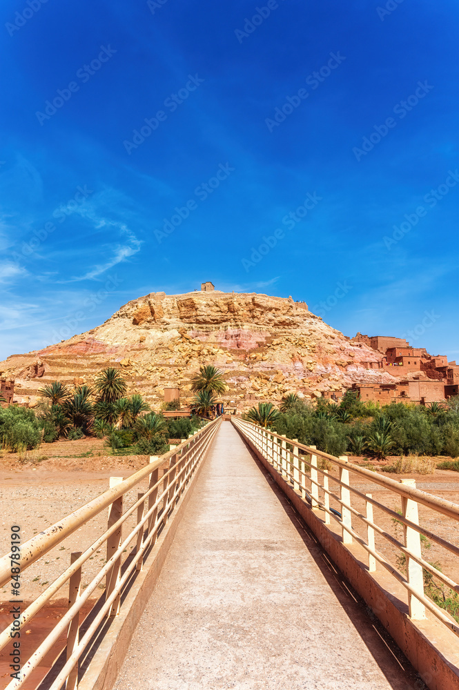 Bridge leading to the fortified village kasbah (ksar) of Aït Benhaddou in the foothills of the High Atlas Mountains