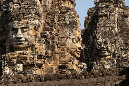 Three giant stone face at the Bayon Temple at Angkor Wat, Cambodia. photo
