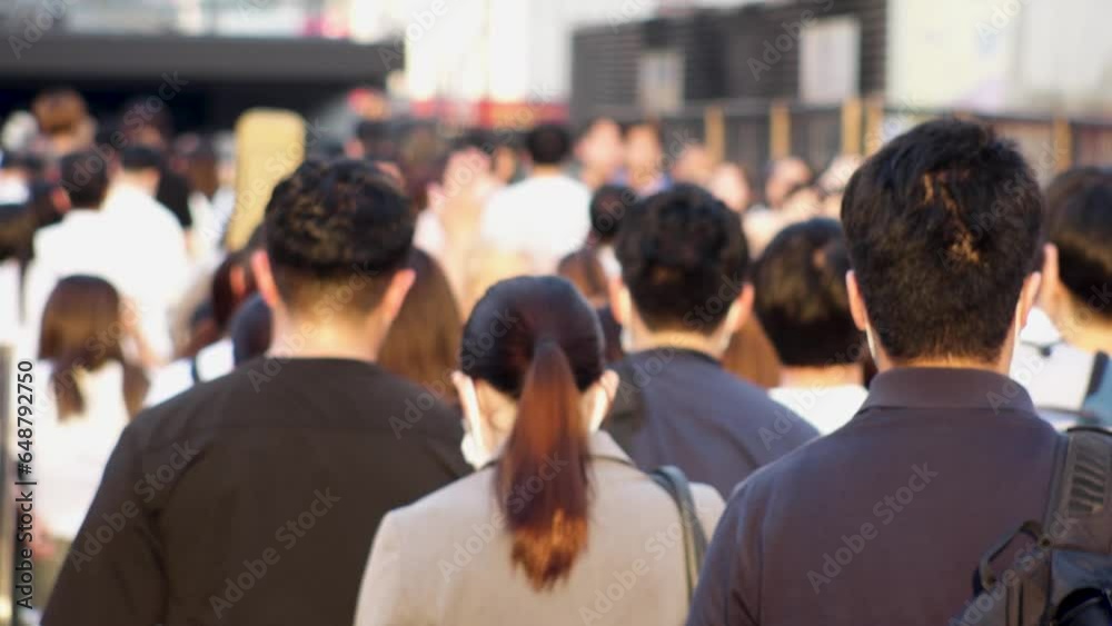Slow motion shot of crowd of people walking in Osaka, Japan. Back shot of unidentified men and women. Shot in sunset time, busy rush hour. Japanese people and urban city lifestyle concept video. Slow motion shot of crowd of people walking in Osaka, Japan. Back shot of unidentified men and women. Shot in sunset time, busy rush hour. Japanese people and urban city lifestyle concept video.