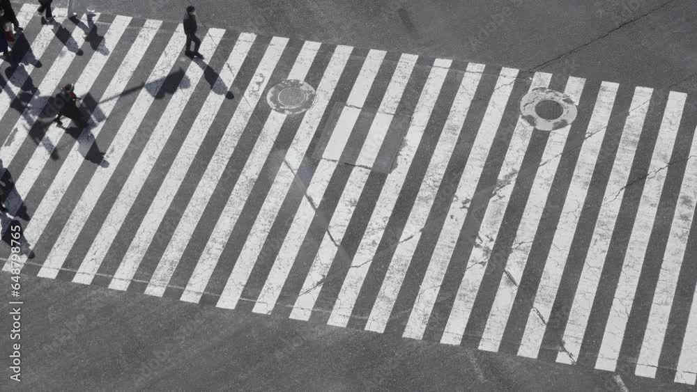 Bird's-eye view of people crossing the road at Shibuya scramble crossing in Japan