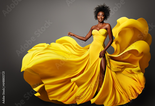 Wallpaper Mural Fashion Woman in Yellow Silk Dress flowing on Wind. Dark Skinned Model with Afro Hairstyle in Long Fantasy Gown over Gray. Happy Stylish Girl dancing Torontodigital.ca
