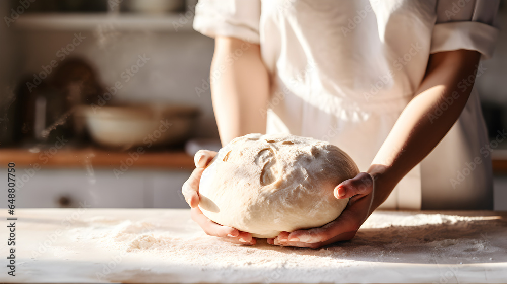 Woman's hands kneading dough to make organic sourdough bread loaf n a home bakery - obrazy, fototapety, plakaty 