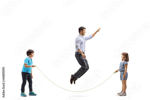 Girl and boy playing skipping rope with their father