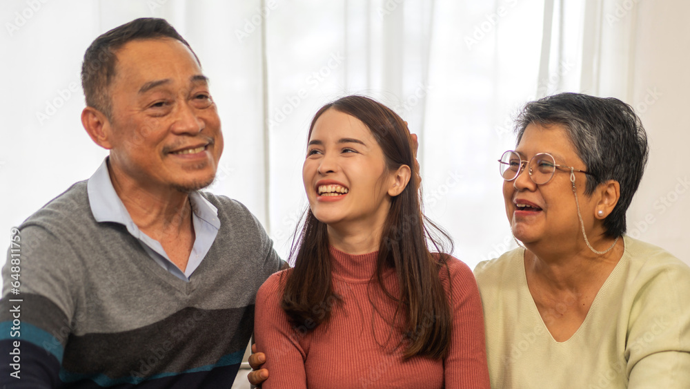 Portrait enjoy happy smiling love asian family.Senior mature father hug with elderly mother and young adult woman play laughing and having fun together at home.insurance concept Portrait enjoy happy smiling love asian family.Senior mature father hug with elderly mother and young adult woman play laughing and having fun together at home.insurance concept