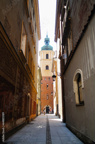 Extremely narrow street for pedestrians in the old town of Lublin. Poland. Dark street in the day. Old architecture, old street. photo