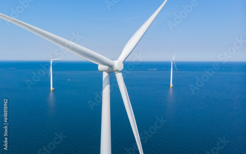 aerial view of windmill turbines in the ocean at the Netherlands, green energy concept windmill turbines