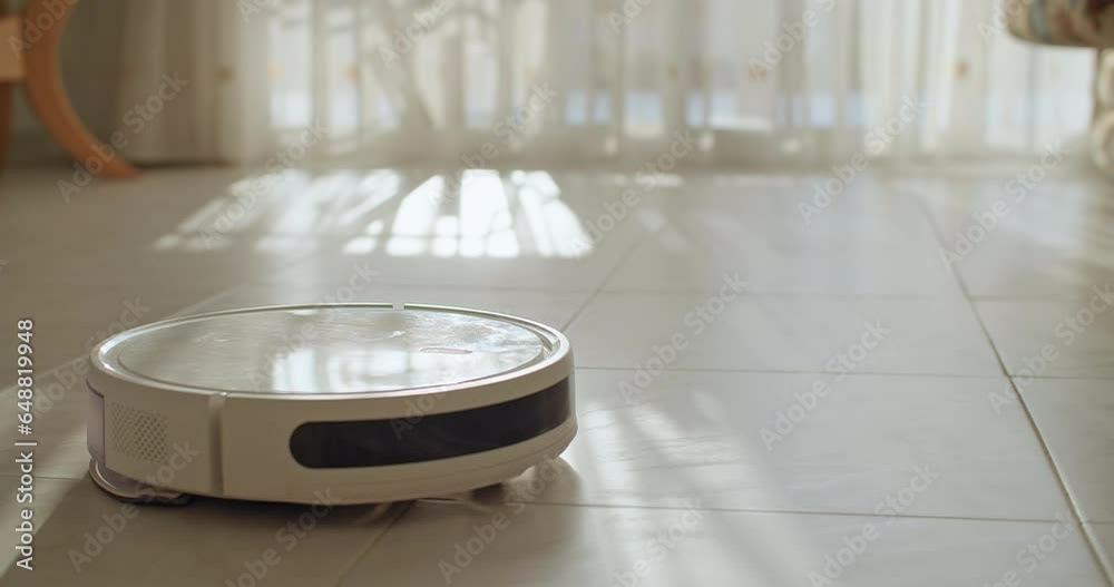 A close-up of a robot vacuum cleaner that automatically cleans the house. A smart home and the latest technological assistants for vacuuming the floor. High quality 4k footage A close-up of a robot vacuum cleaner that automatically cleans the house. A smart home and the latest technological assistants for vacuuming the floor. High quality 4k footage