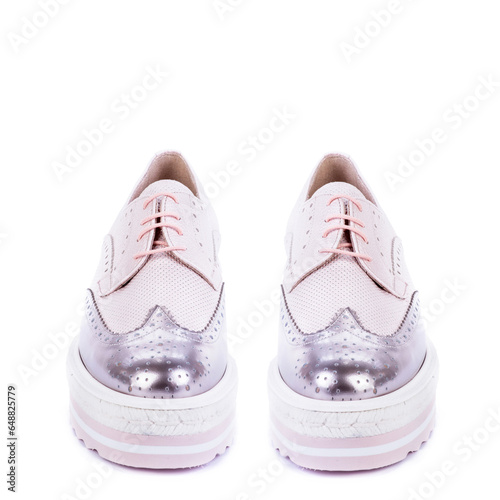 Front view of  ywo pastel leather women's oxford shoes with a chunky platform and metallic leather toe isolated on a white background with copy space. Discount promotion layout for e-commerce store. photo