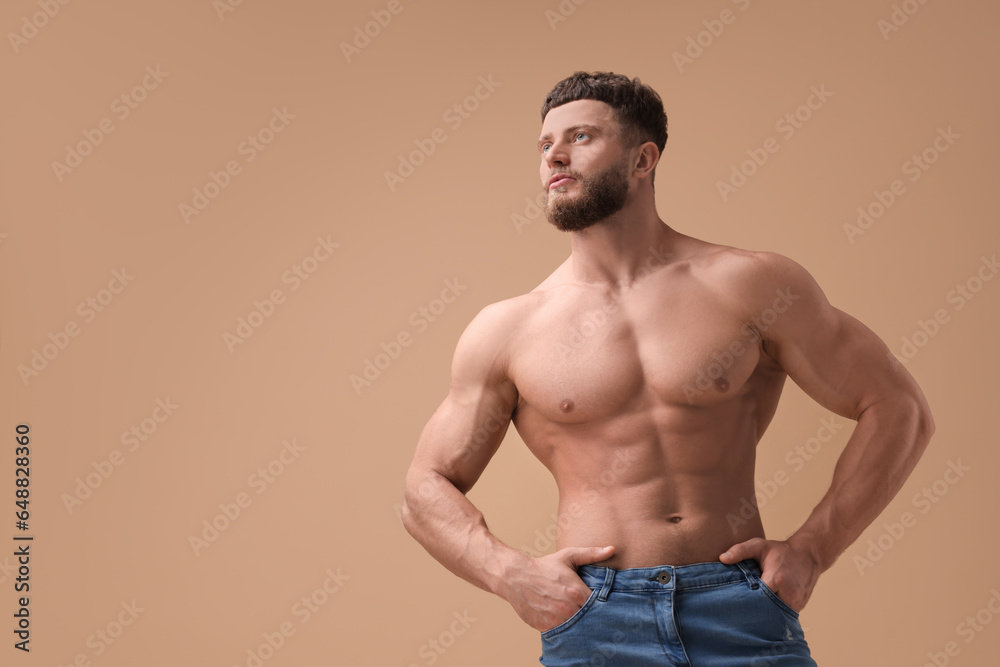 Handsome muscular man on beige background, space for text. Sexy body