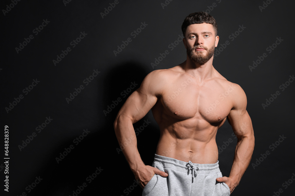 Fototapeta premium Handsome muscular man on black background, space for text. Sexy body