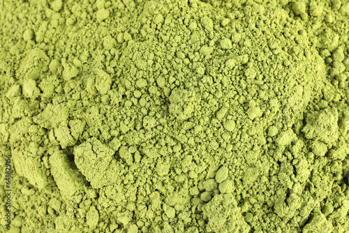 Green matcha powder as background, top view