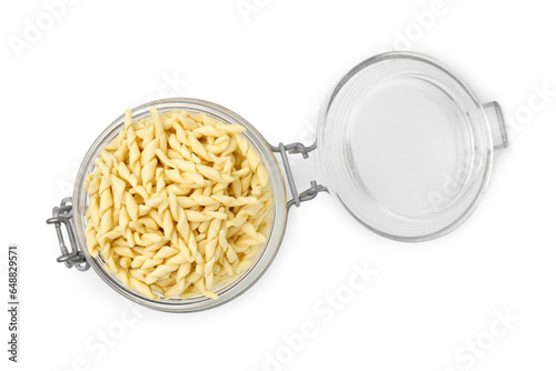 Uncooked trofie pasta in glass jar isolated on white, top view photo