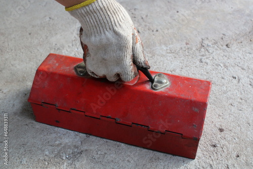 Red mechanic tool box,holding a tool box