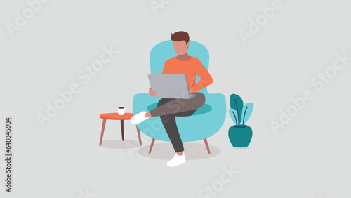 A European man sits on a sofa and works relaxed in his home office