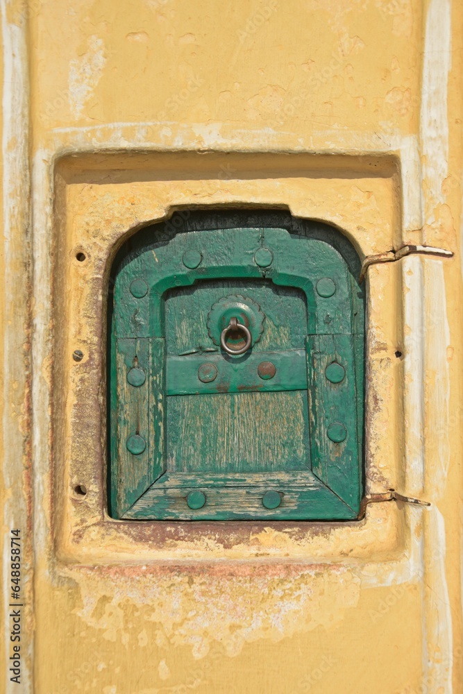 small window with wooden door at Hawa Mahal, Jaipur, Rajasthan , India 