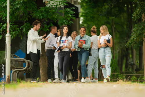 Young high school students standing together outside