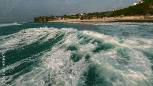 Surfing in slow motion. FPV drone view in ocean (Bali)