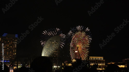 SAKURAGICHO, YOKOHAMA, JAPAN - 31 JULY 2023 : View of FIREWORKS and buildings at Minato Mirai area. Japanese summer season and festival concept video. photo