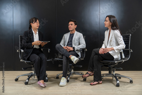 Ceremonial seminar, Asian woman wearing glasses, team interview, topic, work concept, male executive and caucasian female employee on conference room stage