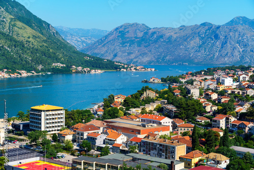 view of the old town of Kotor in Montenegro and the coast of the Bay of Kotor, the sea and medieval European architecture, city streets, red tiled roofs, the concept of traveling across the Balkans