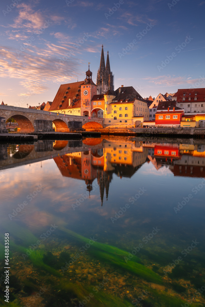 Regensburg, Germany. Cityscape image of Regensburg, Germany with Old Stone Bridge over Danube River and St. Peter Cathedral at autumn sunrise.