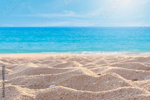 Empty sandy beach and calm sea in summer. Background for banner or product placement.