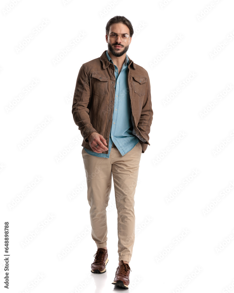 handsome young guy with glasses smiling and walking with hand in pocket handsome young guy with glasses smiling and walking with hand in pocket