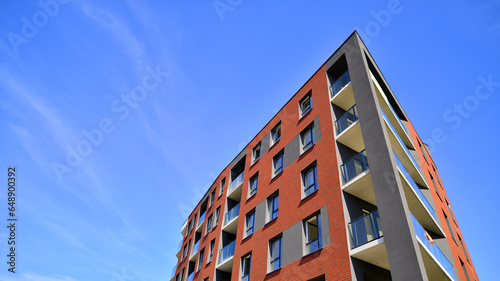 Modern apartment building in a residential area of ​​a city. Contemporary residential building exterior in the daylight. 