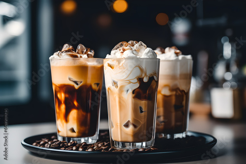 Coffee and milk are mixed in a highball glass with ice. gray wooden table. iced coffee drink in the cafe	 photo
