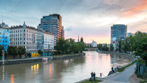Vienna city sklyine from day to night view of  Urania and UNIQA Tower at the Danube Canal Vienna austria time lapse. photo