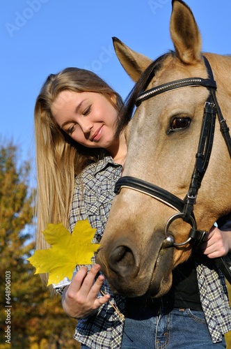 tportrait of teenage girl and horse in sunny autumn day  photo