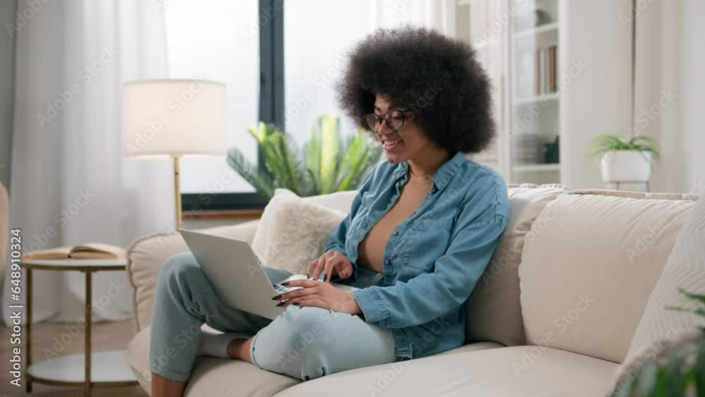 African American woman ethnic girl female user businesswoman freelancer student with laptop excited happy celebrate online win achieve winning with computer achievement screaming with joy at home sofa African American woman ethnic girl female user businesswoman freelancer student with laptop excited happy celebrate online win achieve winning with computer achievement screaming with joy at home sofa