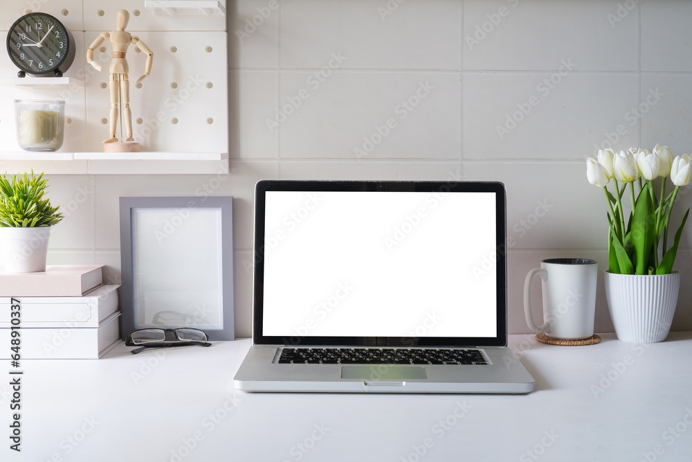 Fototapeta premium Front view laptop, coffee, notebook and houseplant on white table. Blank screen for your advertise text.