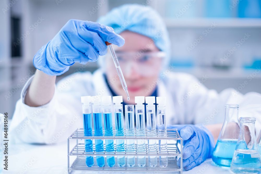 © Supapich - Professional scientist chemist technician analysis research experiment virus blue liquid pipette glass test tube equipment in hospital laboratory, woman doctor white lab coat medical research develop