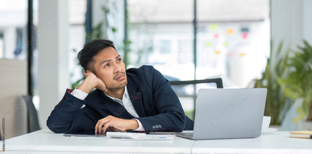 Young unhappy man office worker feeling bored at work, looking at laptop with demotivated face expression while sitting at workplace in office, distracted male worker feeling tired of monotonous job Young unhappy man office worker feeling bored at work, looking at laptop with demotivated face expression while sitting at workplace in office, distracted male worker feeling tired of monotonous job