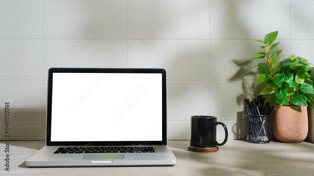 Minimal workplace with laptop computer, coffee cup, pencil holder on white table. Minimal workplace with laptop computer, coffee cup, pencil holder on white table.