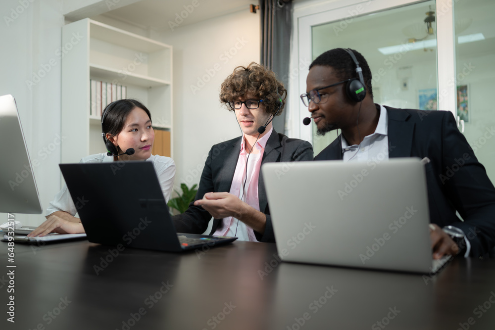 Group of business people wearing headset working actively in office. Call center, telemarketing, customer support agent provide service on telephone video conference call. Group of business people wearing headset working actively in office. Call center, telemarketing, customer support agent provide service on telephone video conference call.