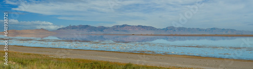 Reflection of the landscape around the Great Salt Lake in Utah, view from the Anetloup island within the lake. 