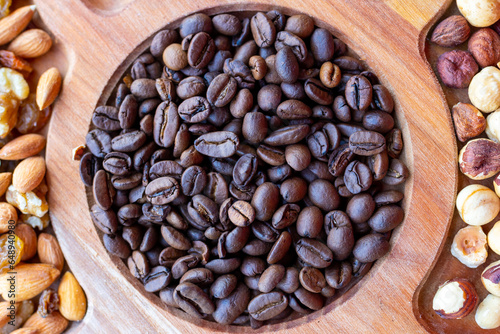 Wooden plate with coffee and mixed beans for snack