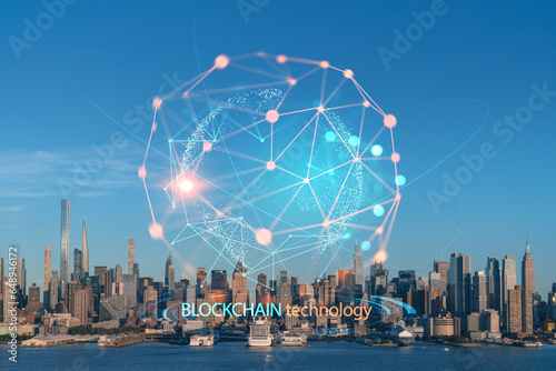 New York City skyline from New Jersey over Hudson River, Midtown Manhattan skyscrapers at sunset, USA. Decentralized economy. Blockchain, cryptography and cryptocurrency concept, hologram