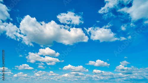 The high cumulus clouds against the blue sky create a stunning background © Андрей Журавлев