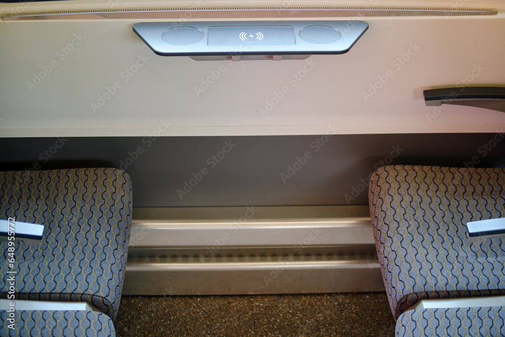 Fototapeta premium Interior of the passenger compartment of a passenger train with wireless charging for phone