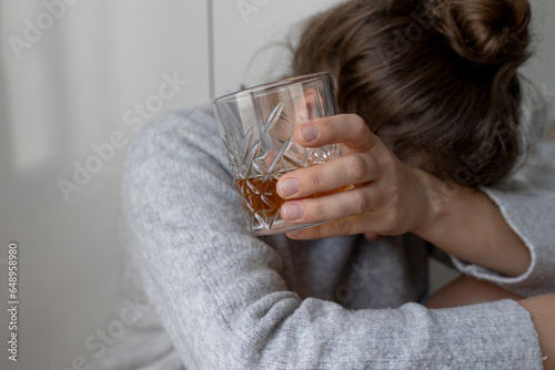 alcoholism, alcohol addiction . drunk woman or female alcoholic drinking whiskey at home. Loneliness and stress. Female alcoholism. 