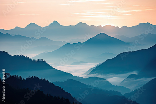 Mountain range with visible silhouettes through the morning colorful fog. © Tjeerd