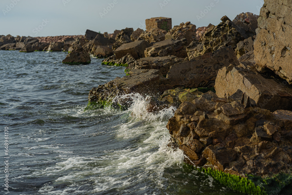 Background of sea waves crashing coast stones.