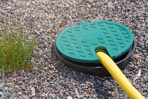 Cuadro en lienzo A plastic hatch in the garden covering the connection point for the irrigation hose