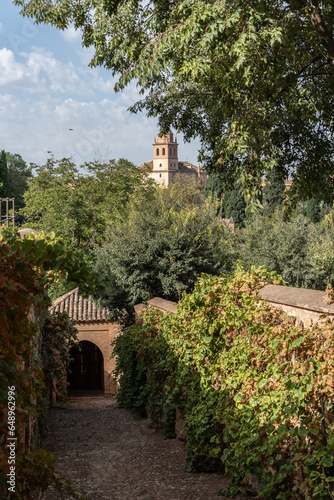 View of the tower of Santa María de la Alhambra from the old access to the Generalife photo