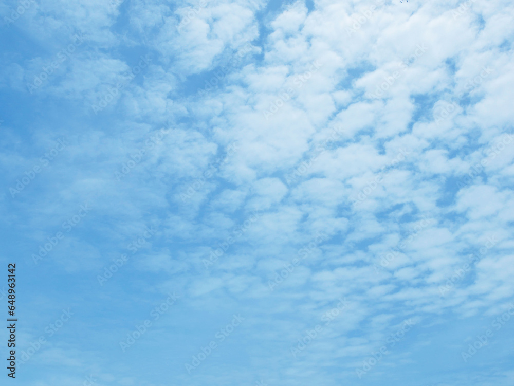 Soft white clouds against blue sky background. Summer blue sky with fluffy cloud
